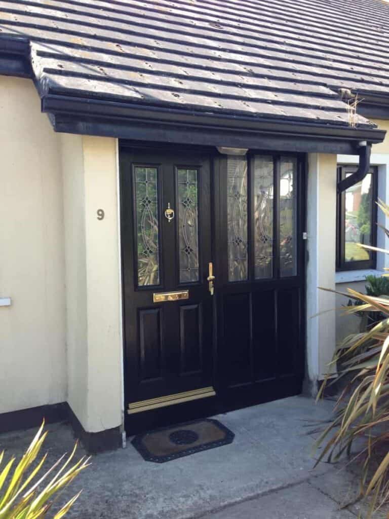 Black front door with decorative glass panels.