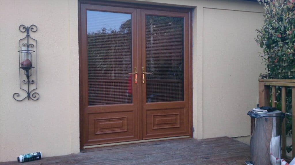Wooden patio doors with decorative sconce