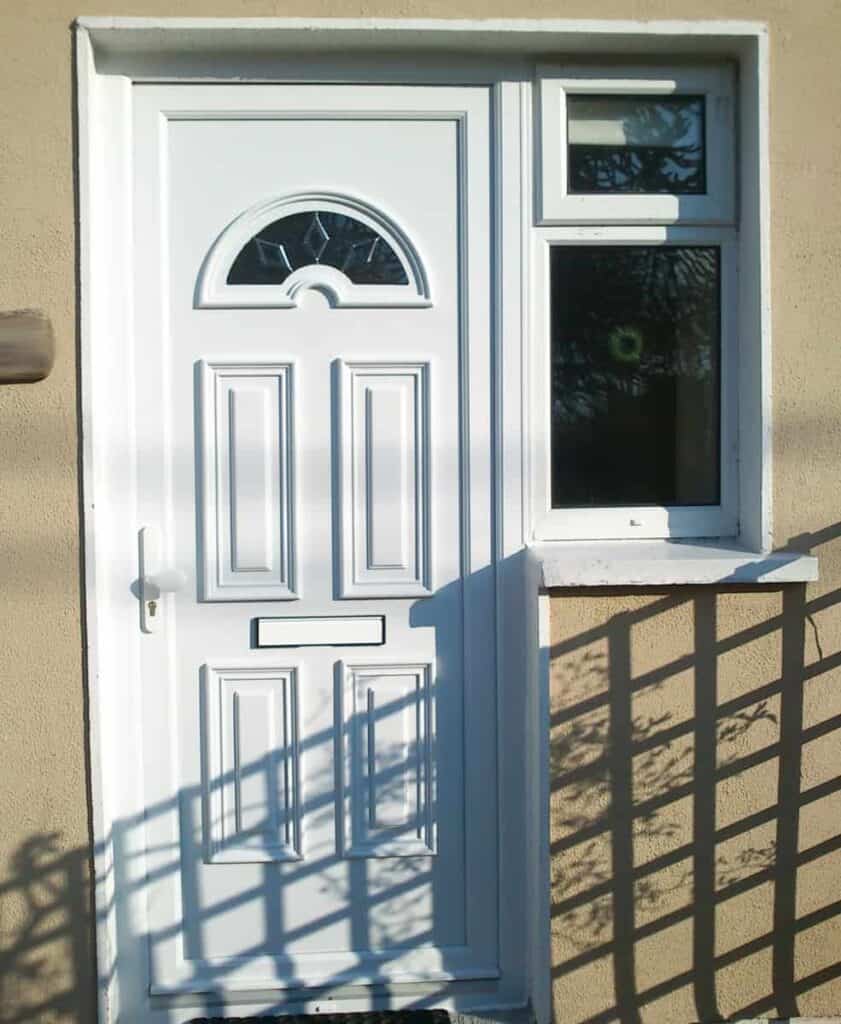 White front door with small window beside it.