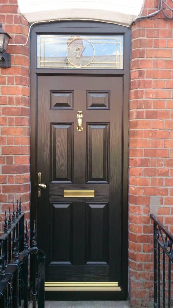 Black front door with gold fixtures and number seven.