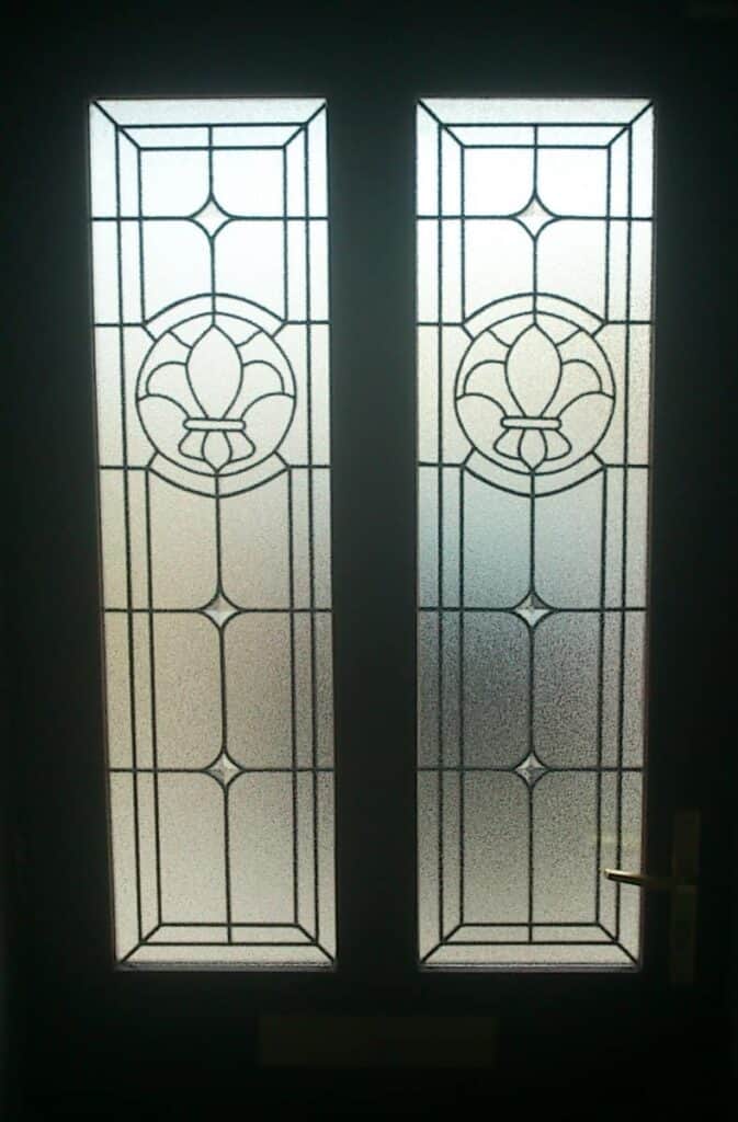 Decorative glass panel door with floral design.