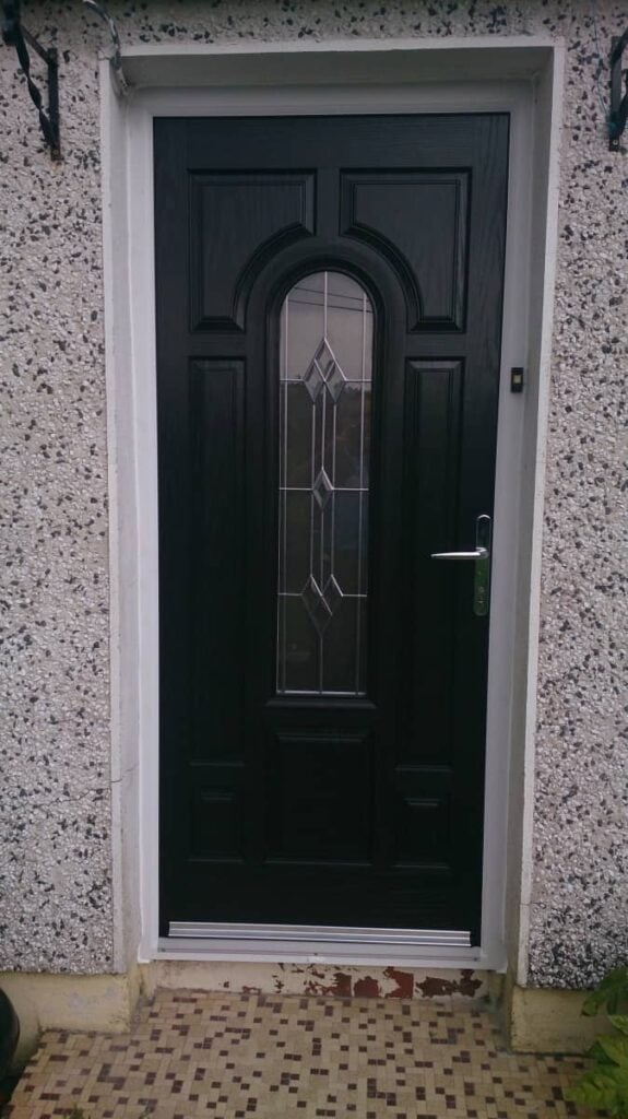 Black front door with decorative glass panel