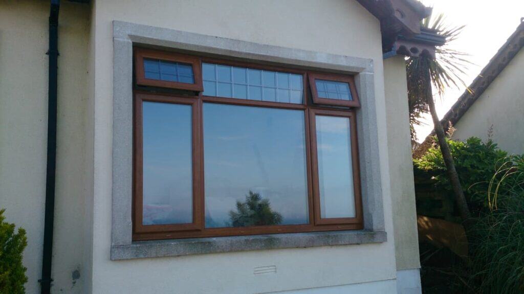 Brown framed house window with garden view