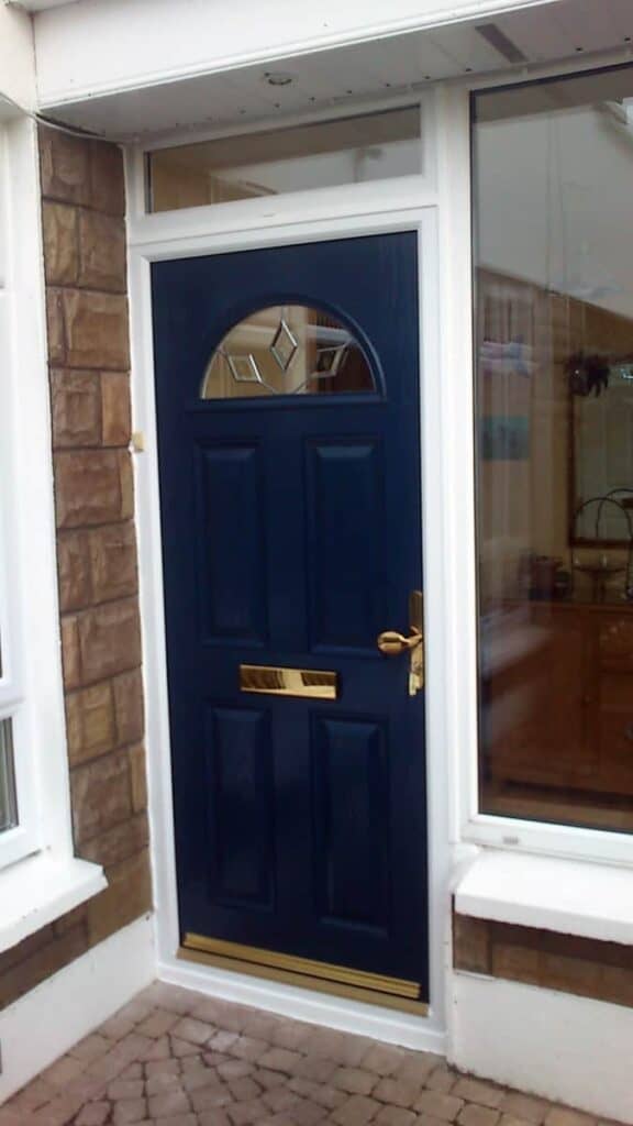 Navy blue front door with decorative glass panel.