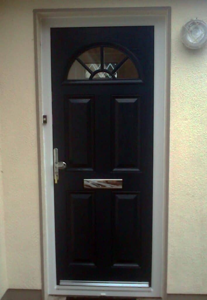 Black front door with letterbox and handle