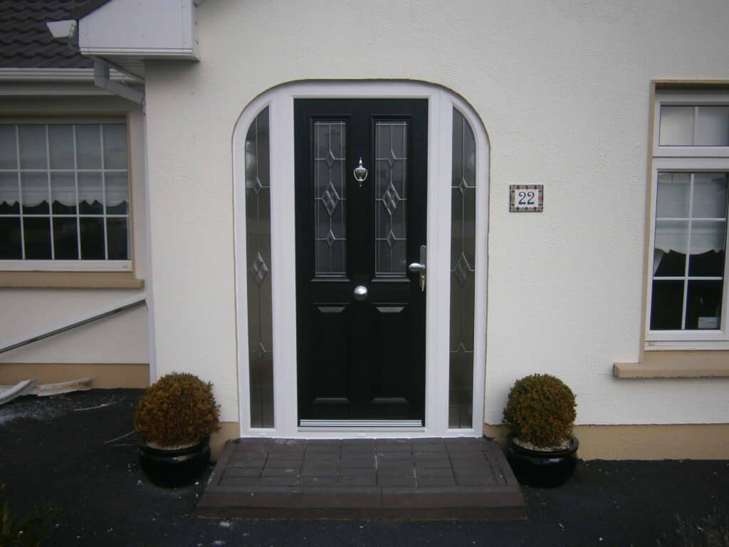 Black front door with decorative glass panels.