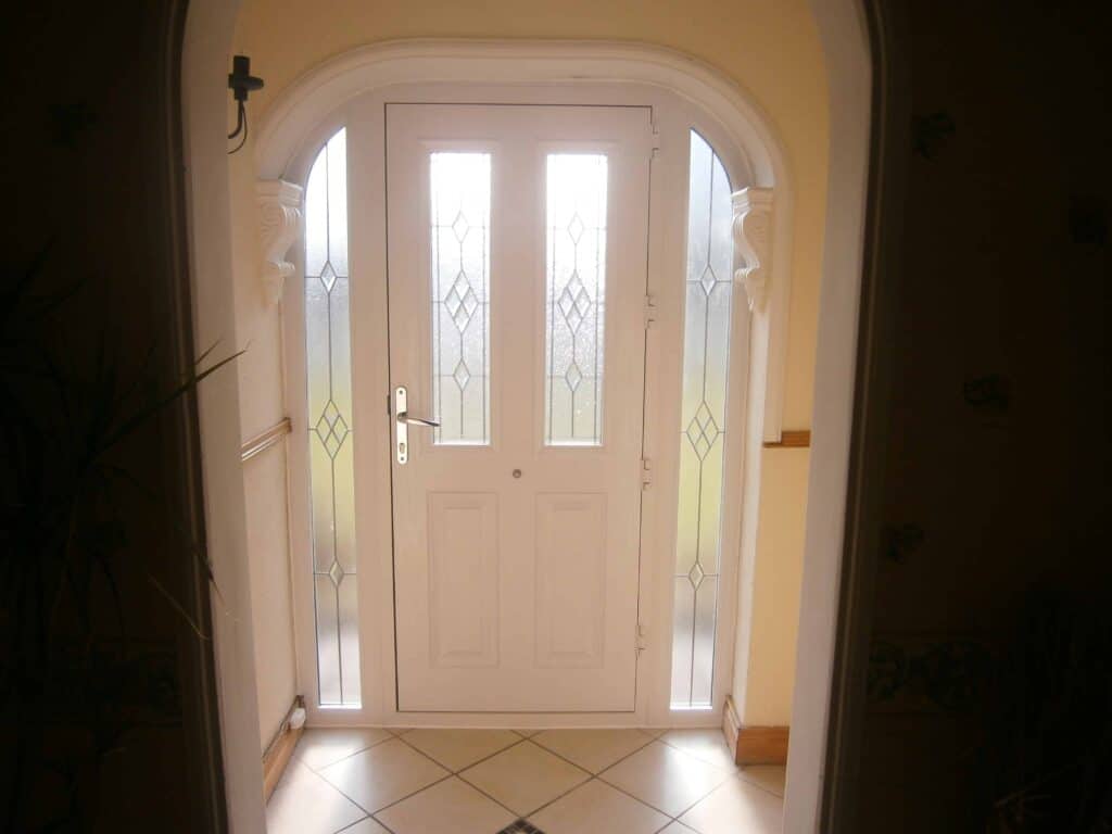 White front door with decorative glass panels
