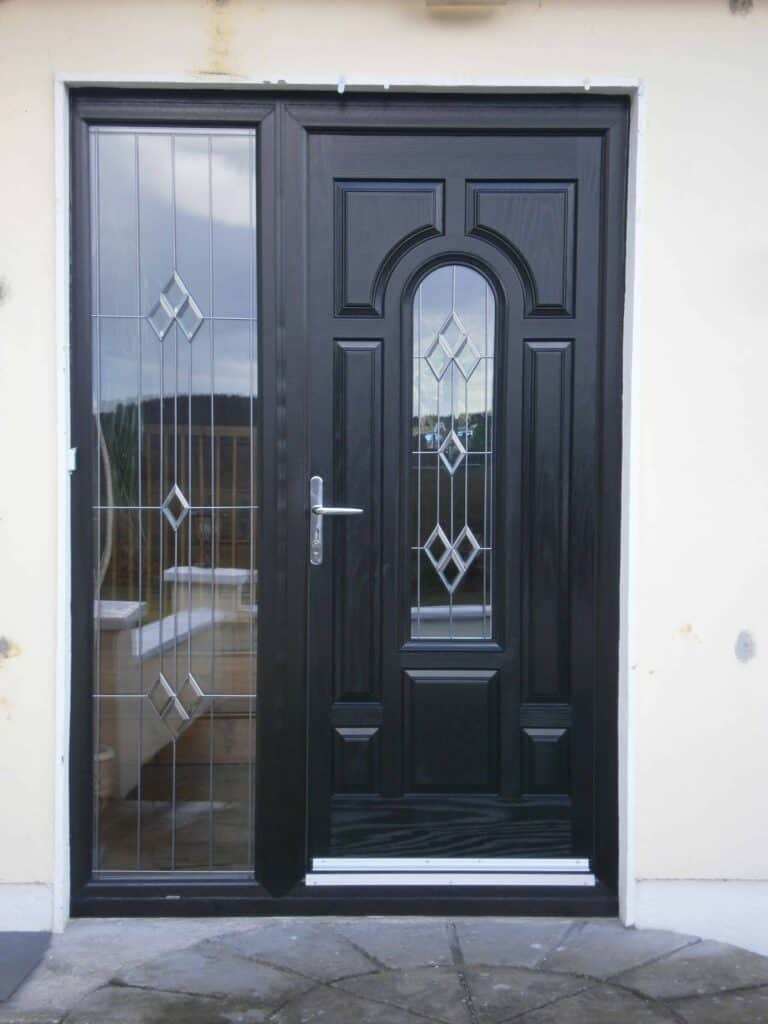 Black front door with glass panels and geometric design.