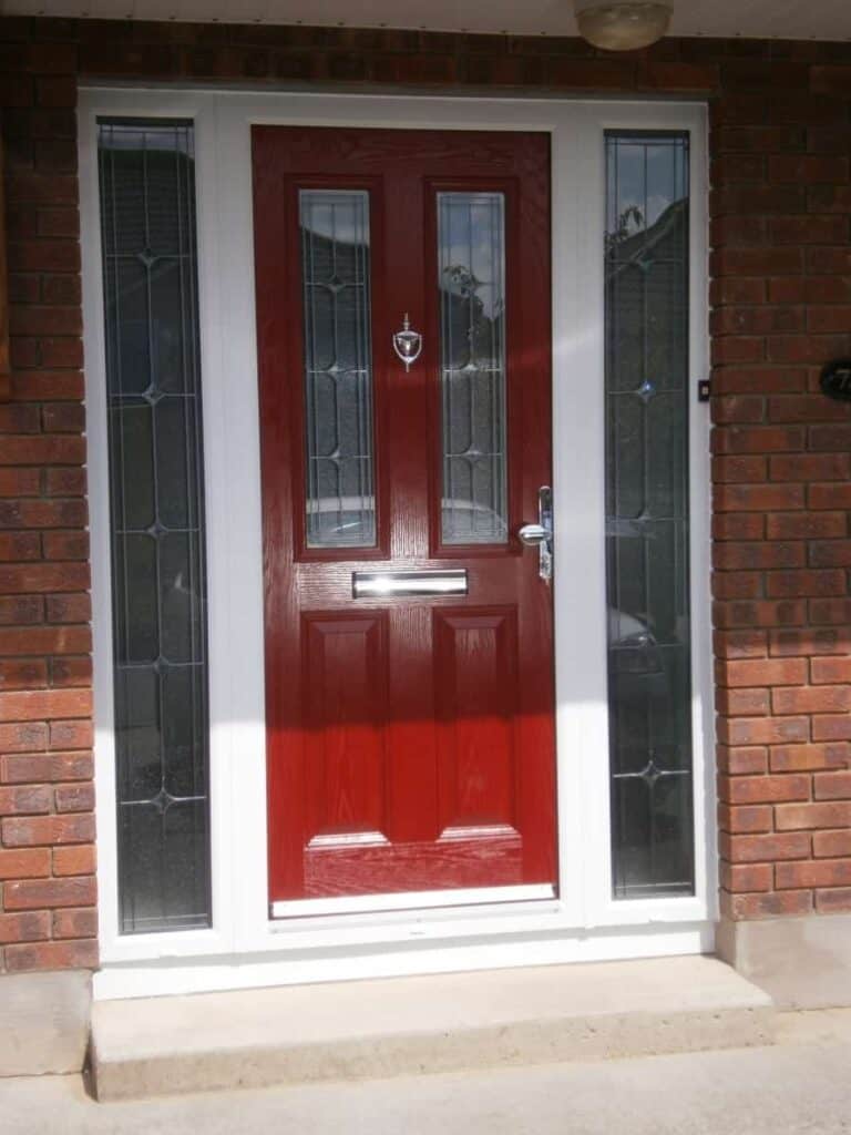 Red front door with glass panels and knocker.